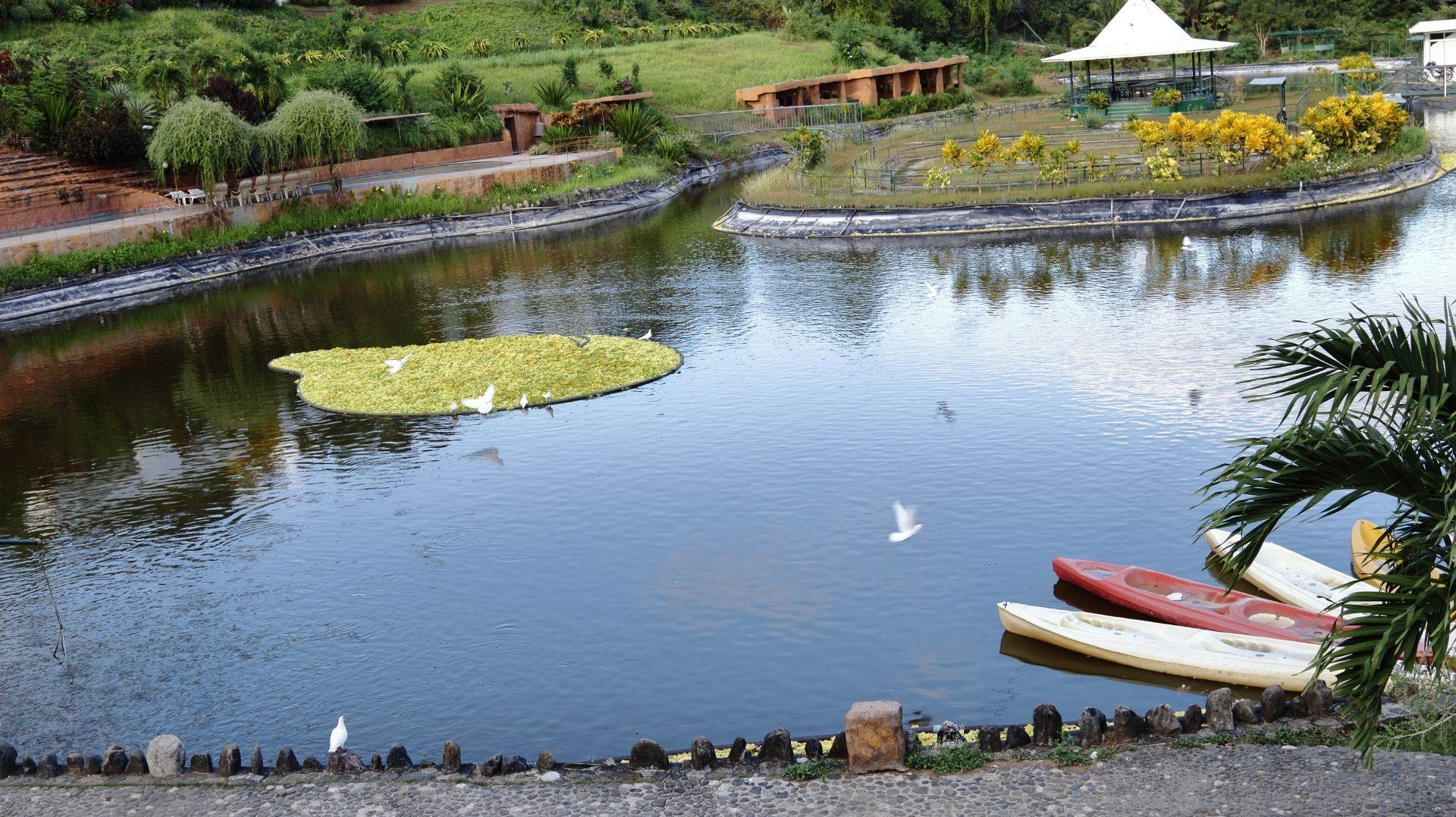 Garin Farm in Miagao, Iloilo, a popular pilgrimage site and tourist attraction with a scenic lake and white cross.