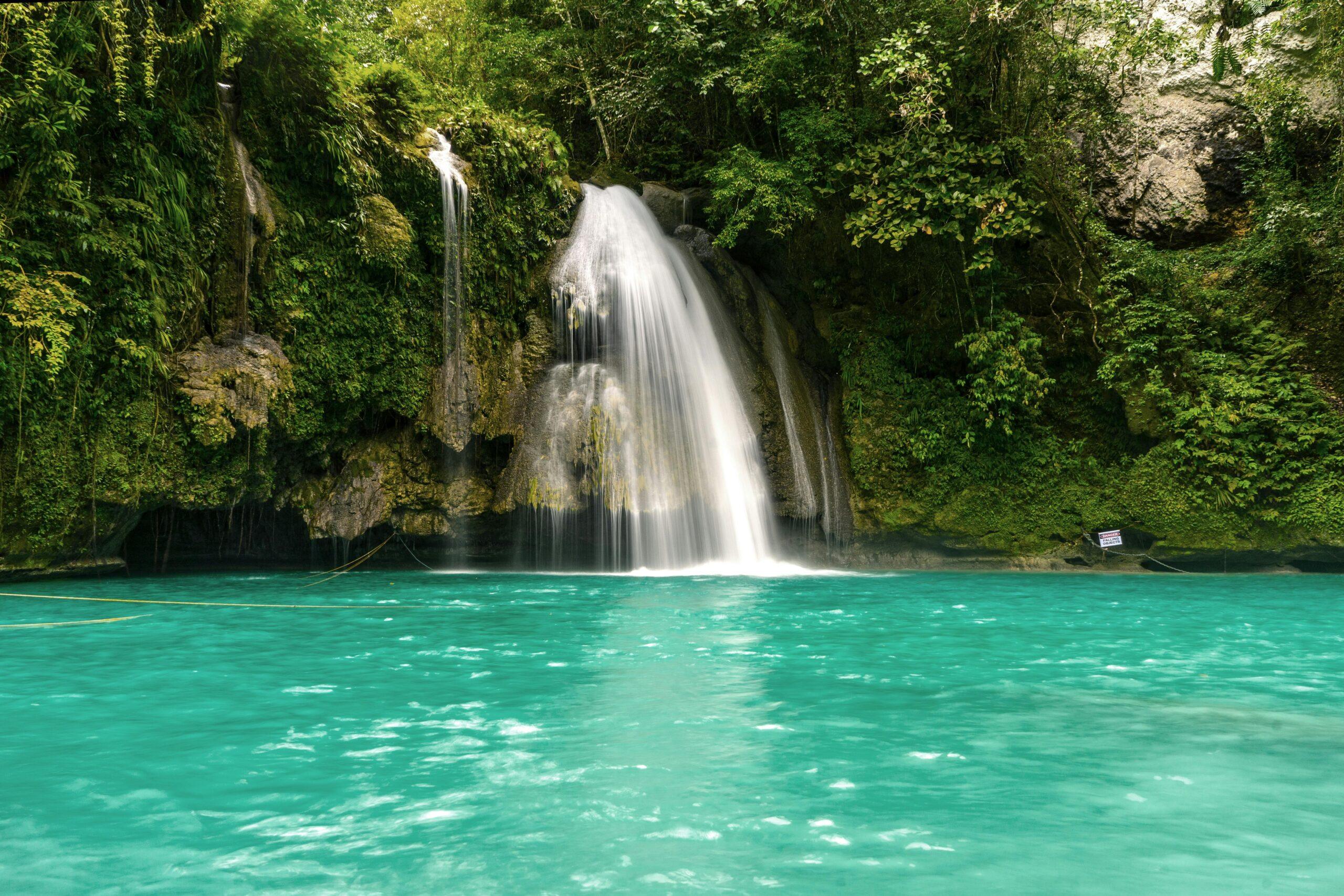 Discover Kawasan Falls, Cebu’s most famous waterfall, offering turquoise pools, jungle scenery, and thrilling canyoneering experiences